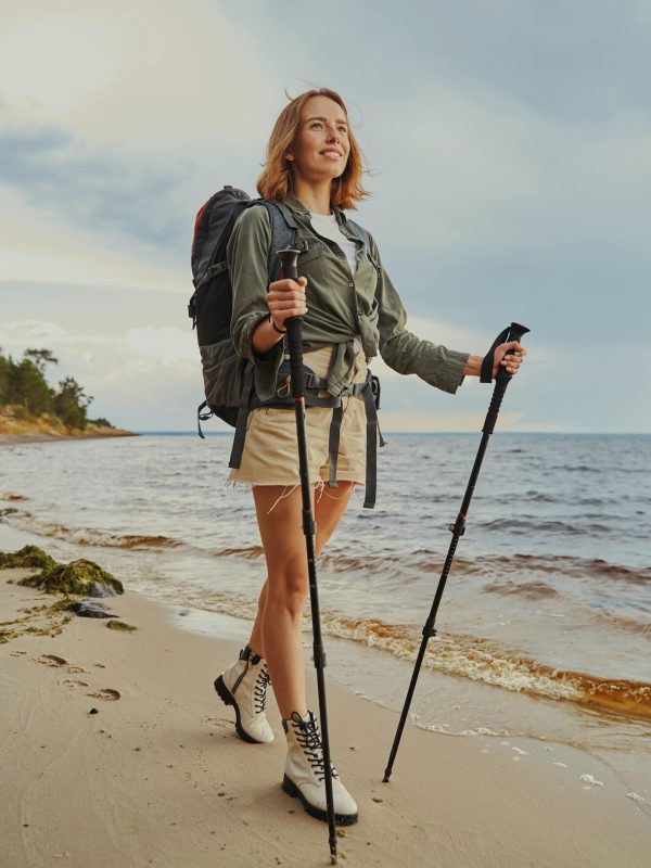 optimistic-traveller-using-walking-poles-during-beach-stroll-1.jpg